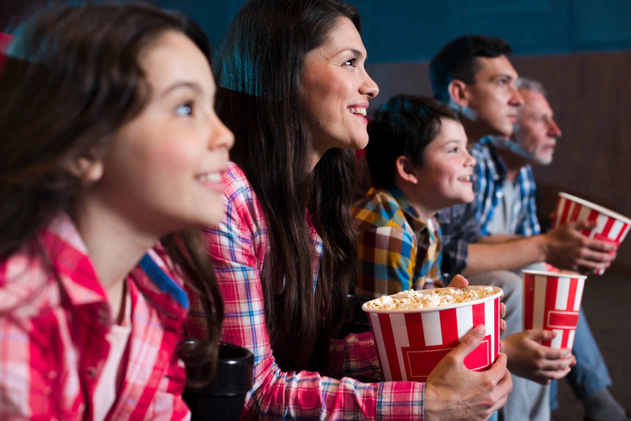 Family using a Roku streaming player to watch movies on a smart TV